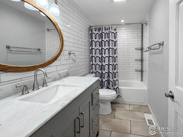 full bathroom featuring tile patterned floors, visible vents, toilet, vanity, and tile walls
