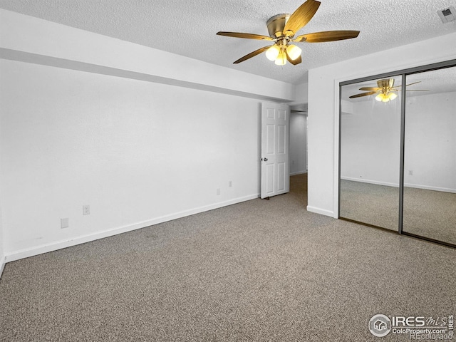 unfurnished bedroom with a closet, carpet floors, a textured ceiling, and a ceiling fan