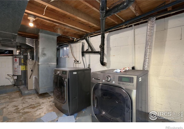 clothes washing area with water heater and independent washer and dryer