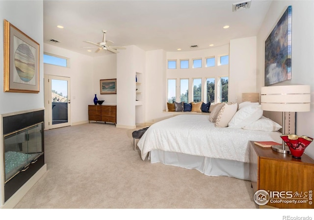 carpeted bedroom featuring ceiling fan and access to outside