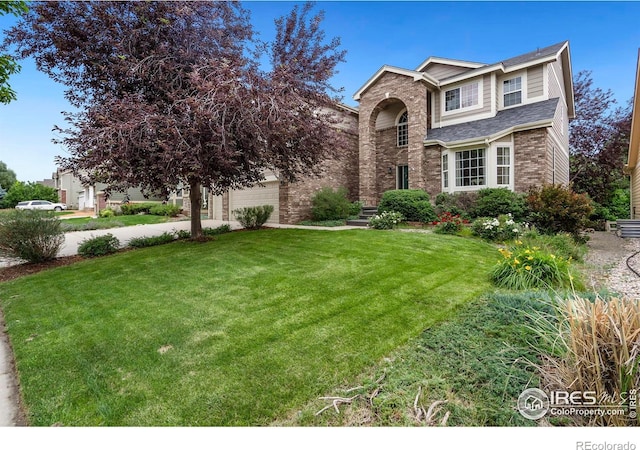 view of front of home with a garage and a front lawn