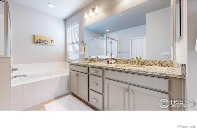 bathroom with tile patterned flooring, plus walk in shower, and vanity