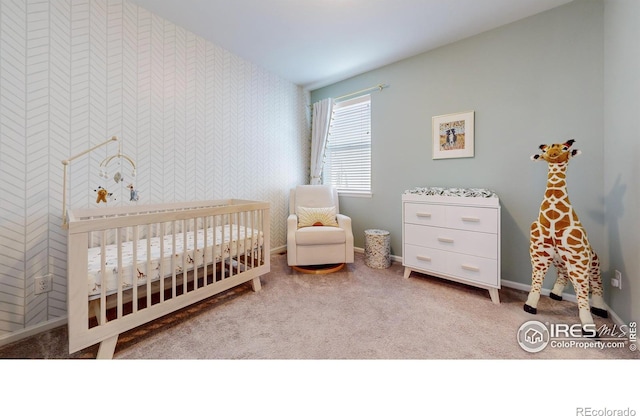 bedroom with a nursery area and light colored carpet