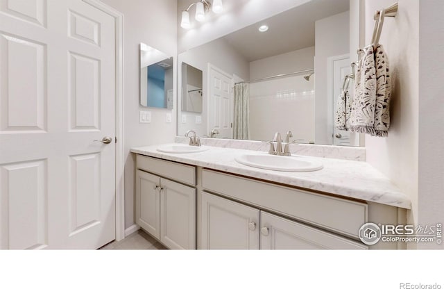 bathroom featuring tile patterned floors, a shower with shower curtain, and vanity