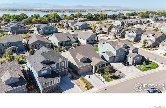 birds eye view of property featuring a water and mountain view