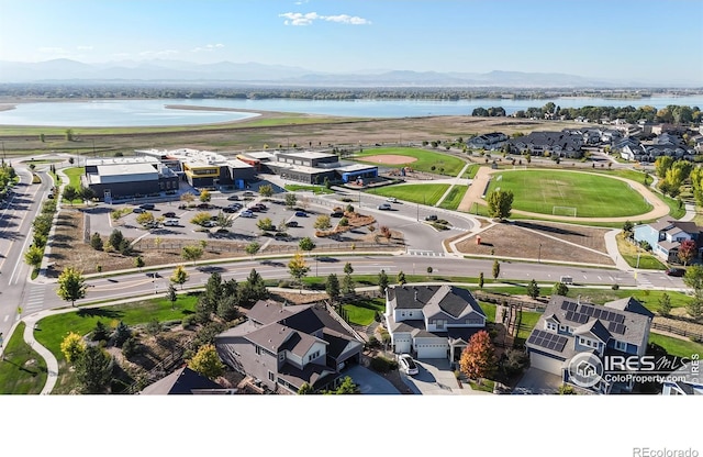 birds eye view of property with a water and mountain view