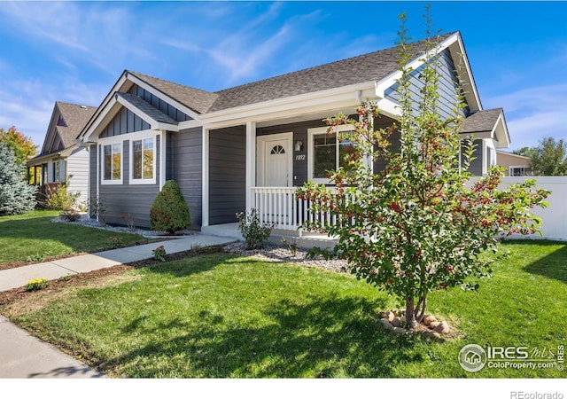 view of front of house with a porch and a front lawn