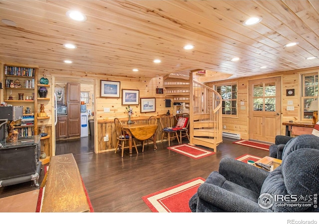 living room with dark hardwood / wood-style floors, wood ceiling, and wooden walls