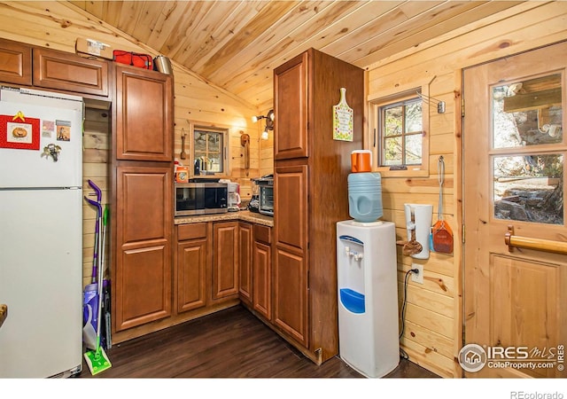 kitchen featuring white refrigerator, wood ceiling, wooden walls, lofted ceiling, and dark hardwood / wood-style floors