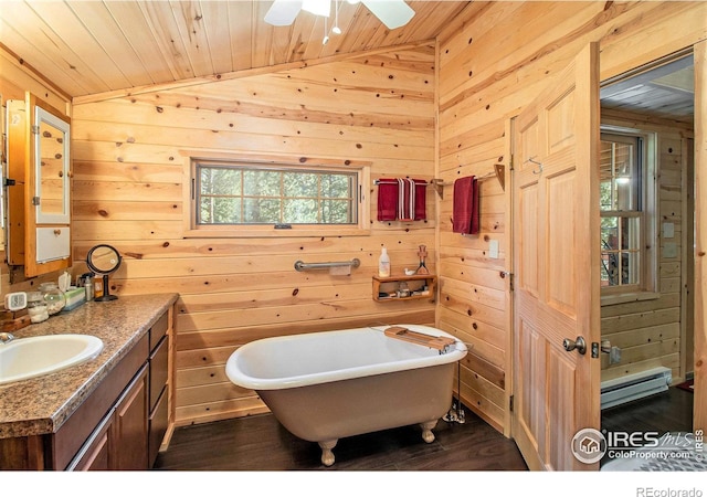 bathroom with wood walls, vaulted ceiling, and vanity