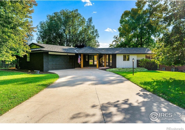 ranch-style home featuring a garage and a front yard