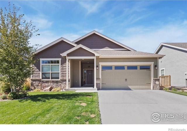 craftsman-style house featuring a front yard and a garage