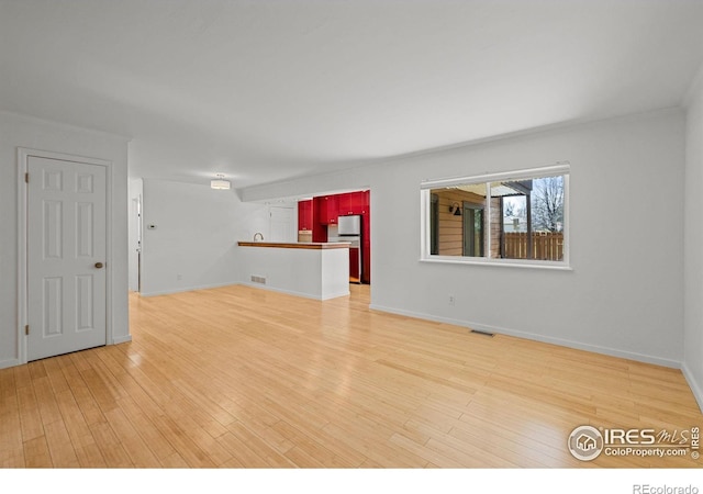 unfurnished living room with hardwood / wood-style flooring