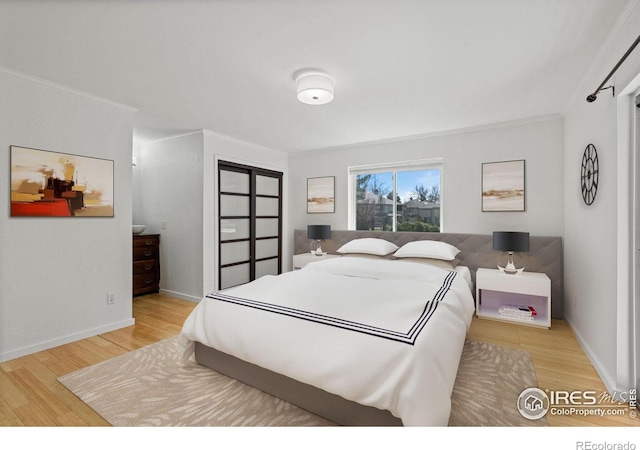 bedroom with ornamental molding and hardwood / wood-style floors