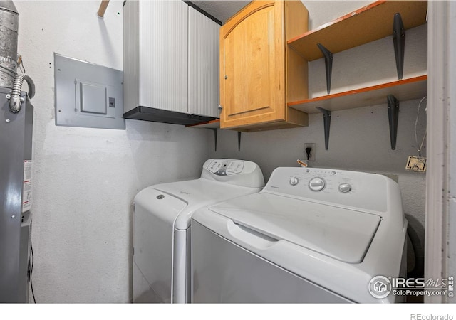 laundry room with cabinets, independent washer and dryer, and electric panel