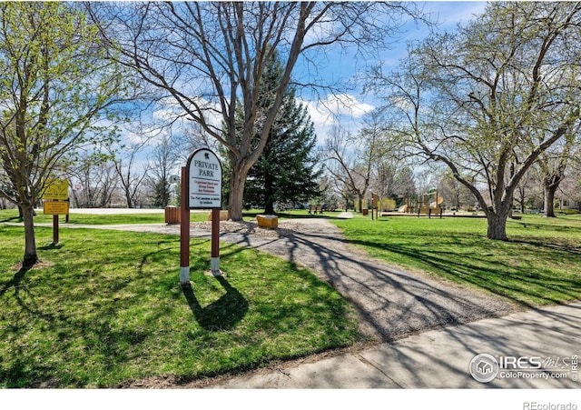 view of property's community with a lawn