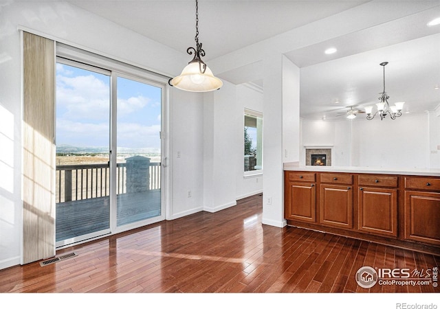 unfurnished dining area featuring dark hardwood / wood-style floors and a chandelier