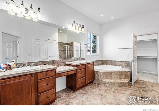 bathroom with vanity and independent shower and bath