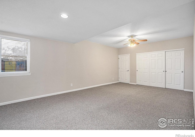 unfurnished bedroom with ceiling fan and carpet flooring