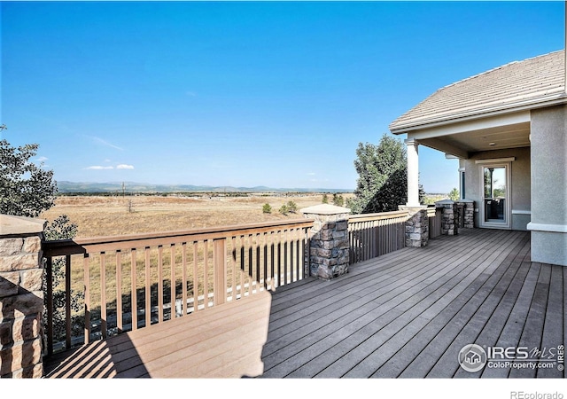 wooden deck featuring a rural view