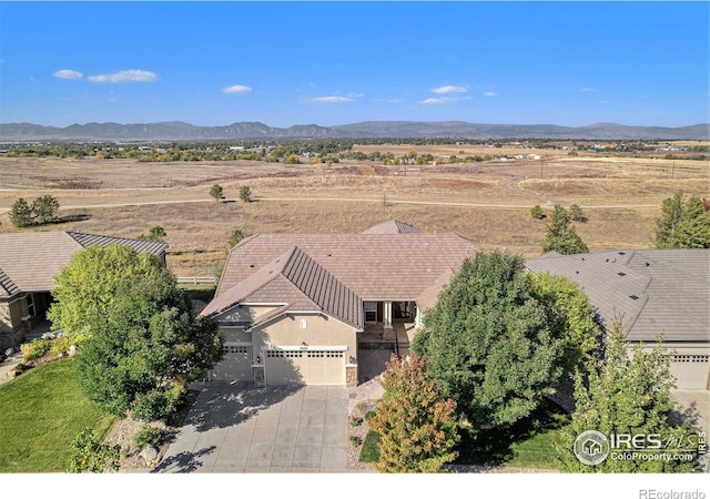 birds eye view of property with a mountain view