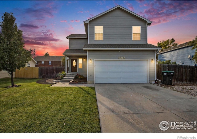 front of property with a garage and a lawn