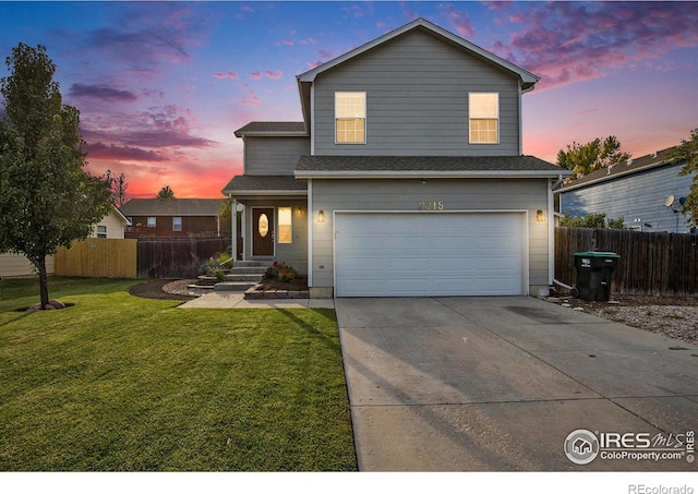 traditional home with a front yard, an attached garage, fence, and concrete driveway