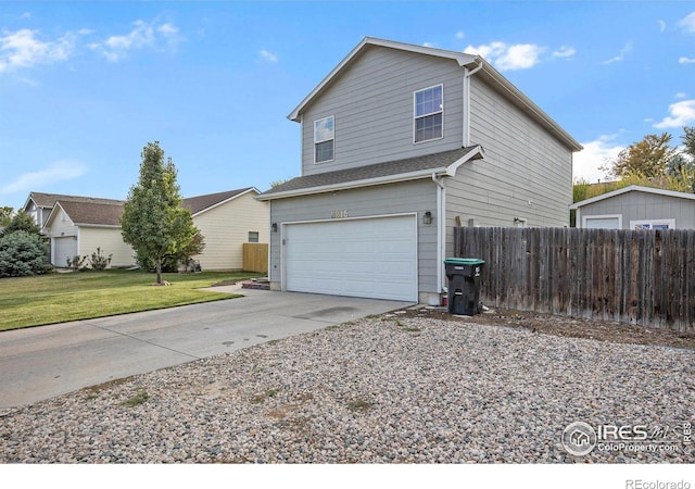view of side of home featuring driveway, a garage, fence, and a lawn