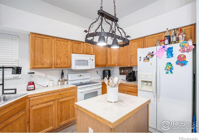 kitchen with white appliances, decorative light fixtures, a kitchen island, and a notable chandelier