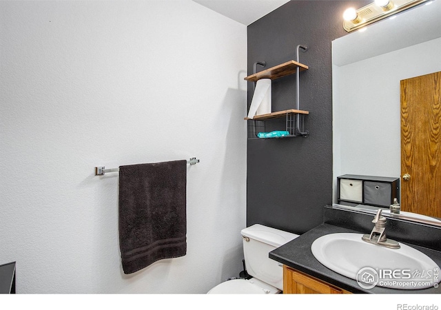 bathroom with toilet and vanity