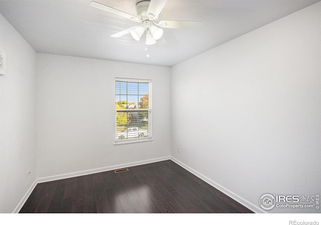 unfurnished room featuring ceiling fan and dark hardwood / wood-style floors