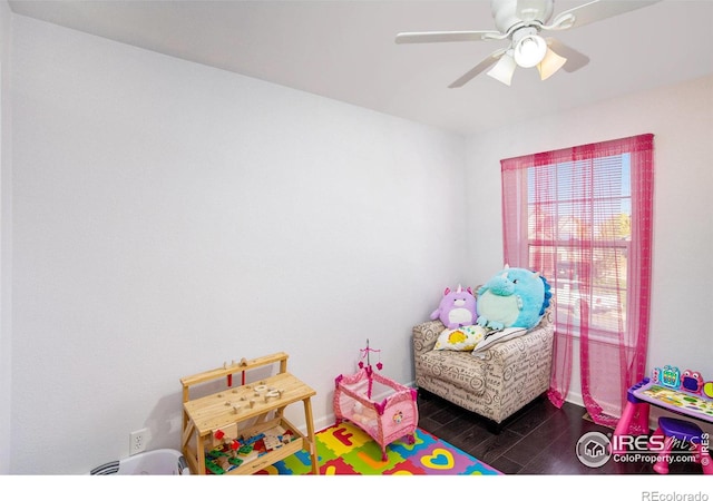 playroom with ceiling fan, baseboards, and wood finished floors