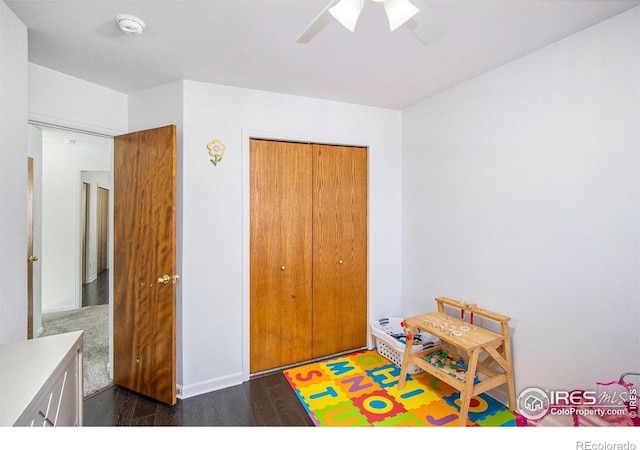 playroom featuring ceiling fan, wood finished floors, and baseboards