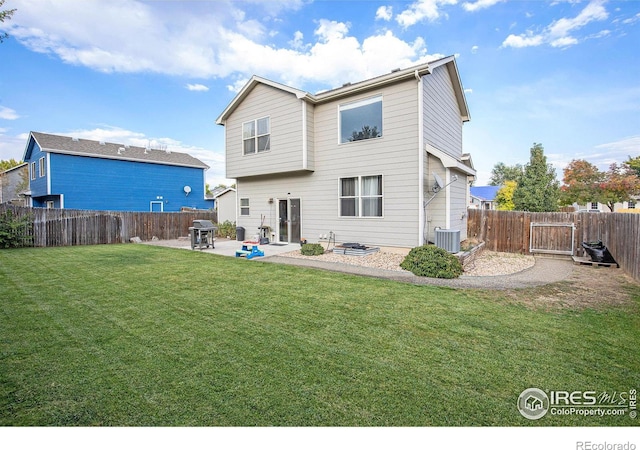 rear view of property with central air condition unit, a lawn, and a patio area