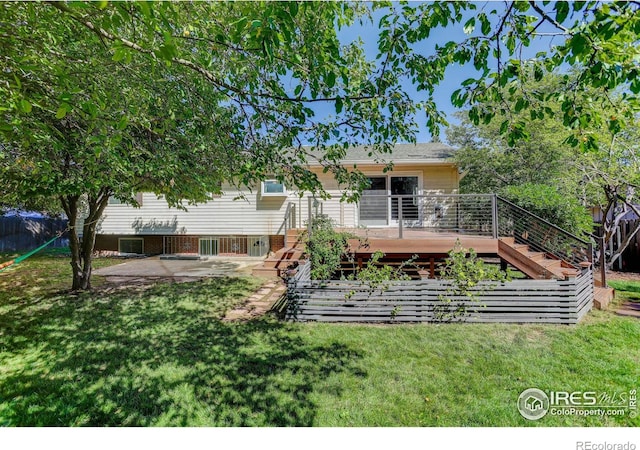 back of property featuring a yard, a deck, and a patio area