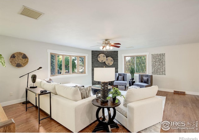 living room featuring hardwood / wood-style flooring and ceiling fan