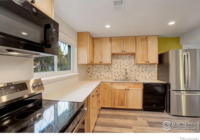 kitchen with light wood-type flooring, black appliances, sink, and light brown cabinets