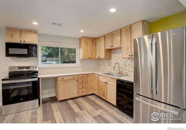 kitchen featuring light brown cabinetry, light hardwood / wood-style floors, black appliances, and sink