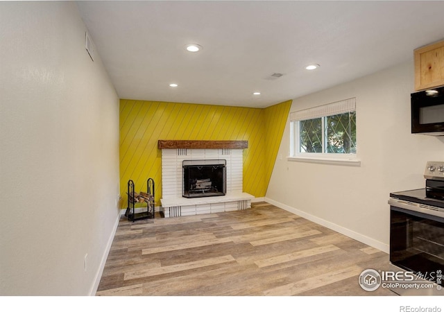 living room featuring wood-type flooring and a fireplace