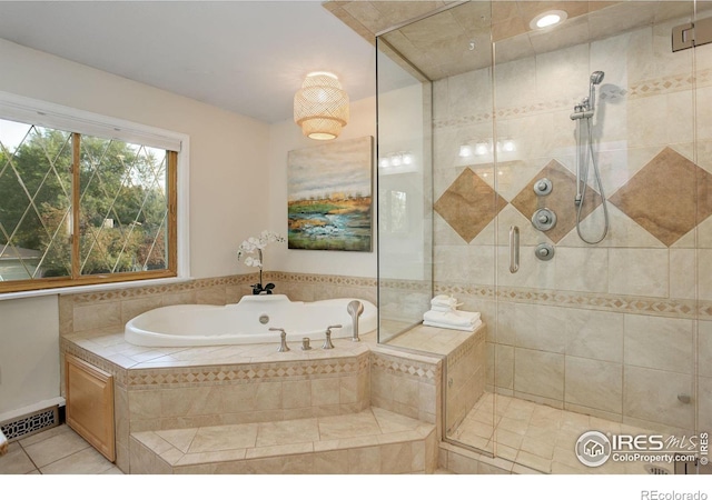 bathroom featuring tile patterned flooring and shower with separate bathtub