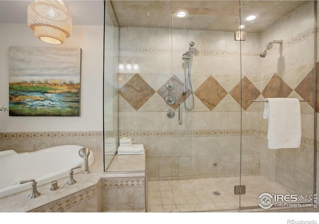 bathroom with shower with separate bathtub