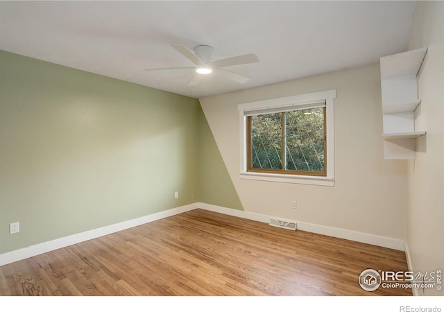 unfurnished room with ceiling fan and light wood-type flooring