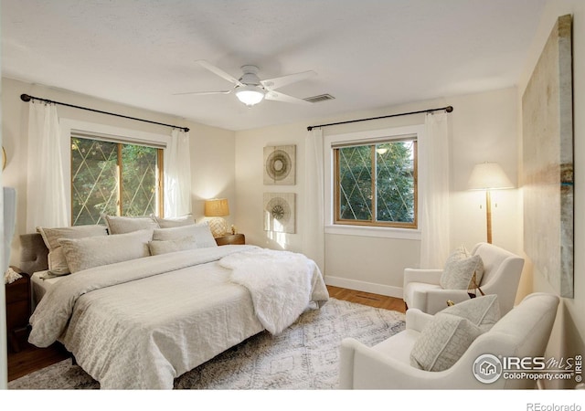 bedroom with hardwood / wood-style flooring and ceiling fan