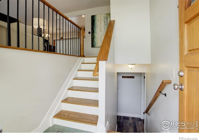 stairway with hardwood / wood-style flooring