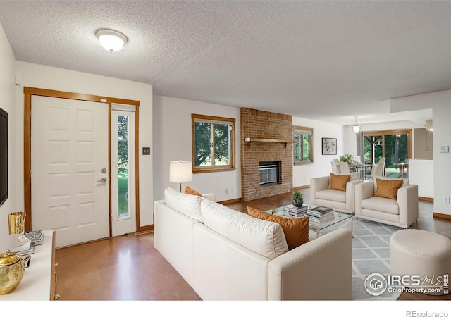 living room with concrete flooring, a textured ceiling, and a fireplace