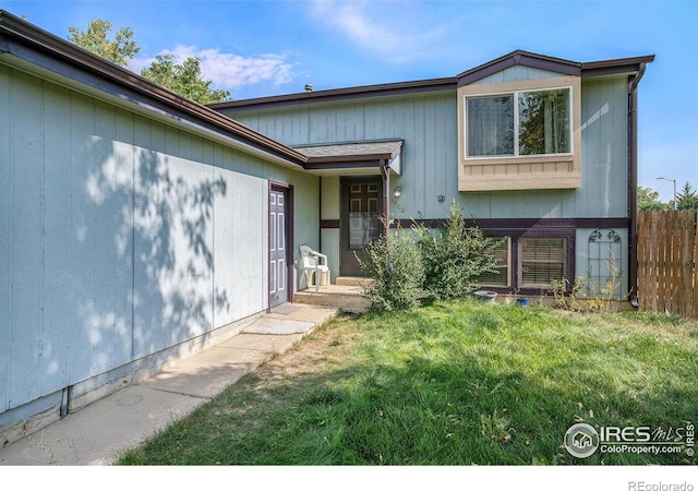 1900 Logan St, Longmont, CO 80501 - view of front of house with fence and a front yard