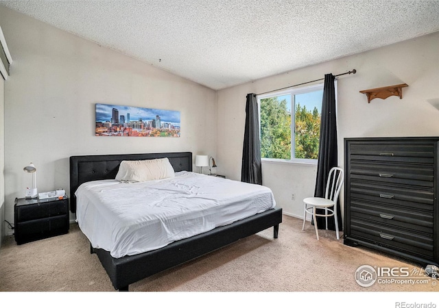 1900 Logan St, Longmont, CO 80501 - bedroom featuring light carpet, a textured ceiling, and vaulted ceiling