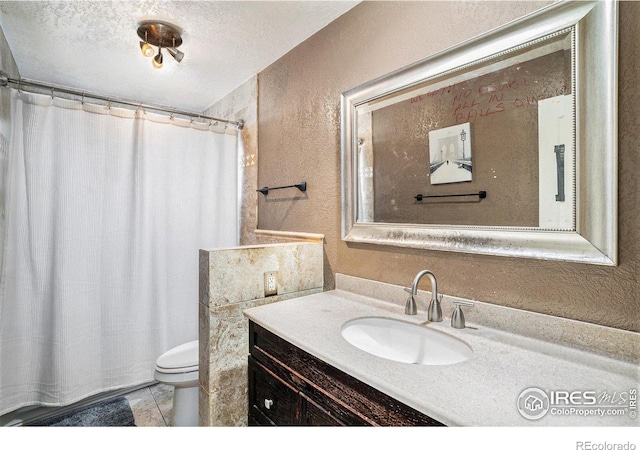 1900 Logan St, Longmont, CO 80501 - bathroom featuring toilet, vanity, curtained shower, tile patterned floors, and a textured wall