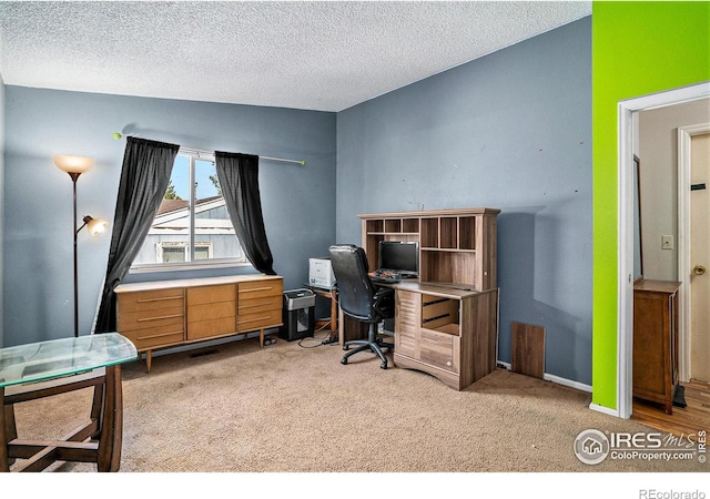 office area with carpet flooring and a textured ceiling