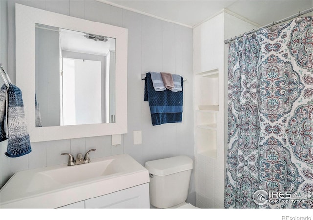1900 Logan St, Longmont, CO 80501 - full bathroom featuring toilet, vanity, crown molding, and a shower with shower curtain